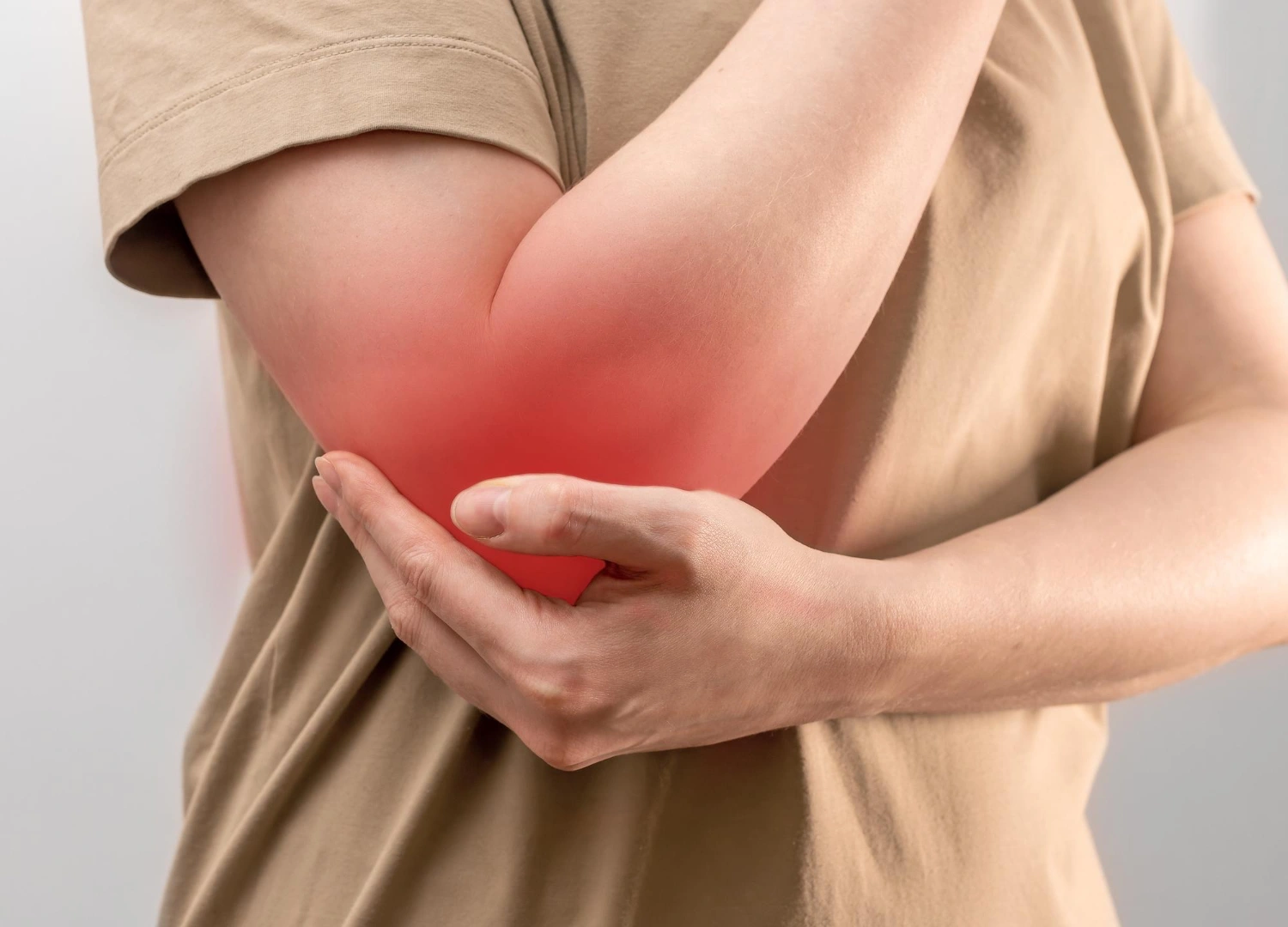 Person holding an inflamed elbow