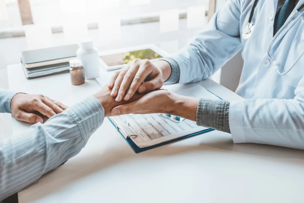 doctor holding the hand of a patient