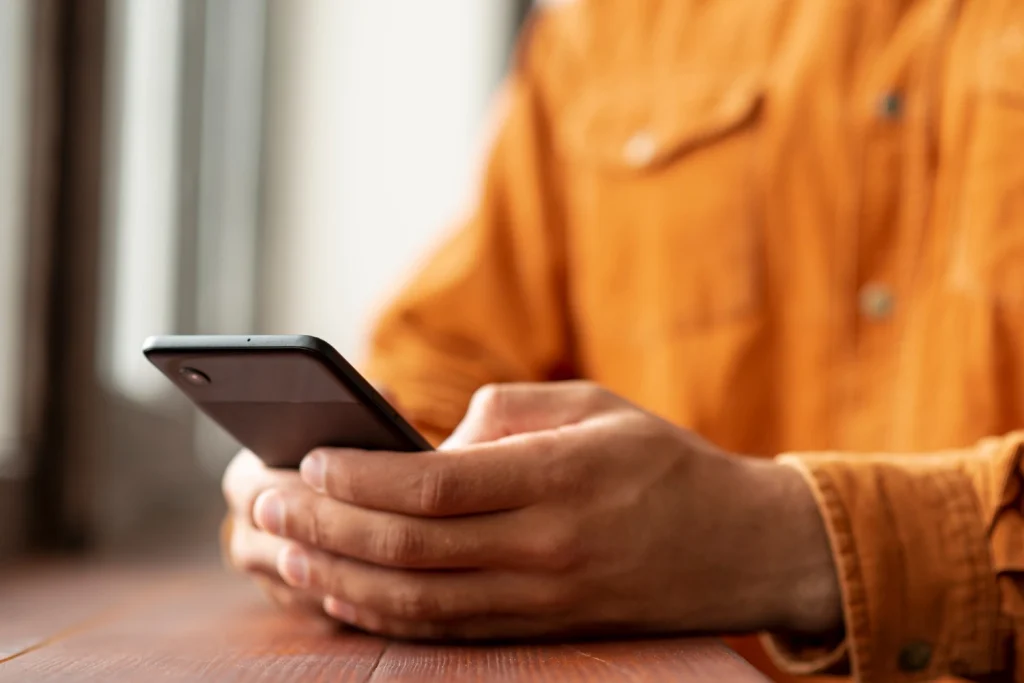 Person using a mobile phone to call for mental health support