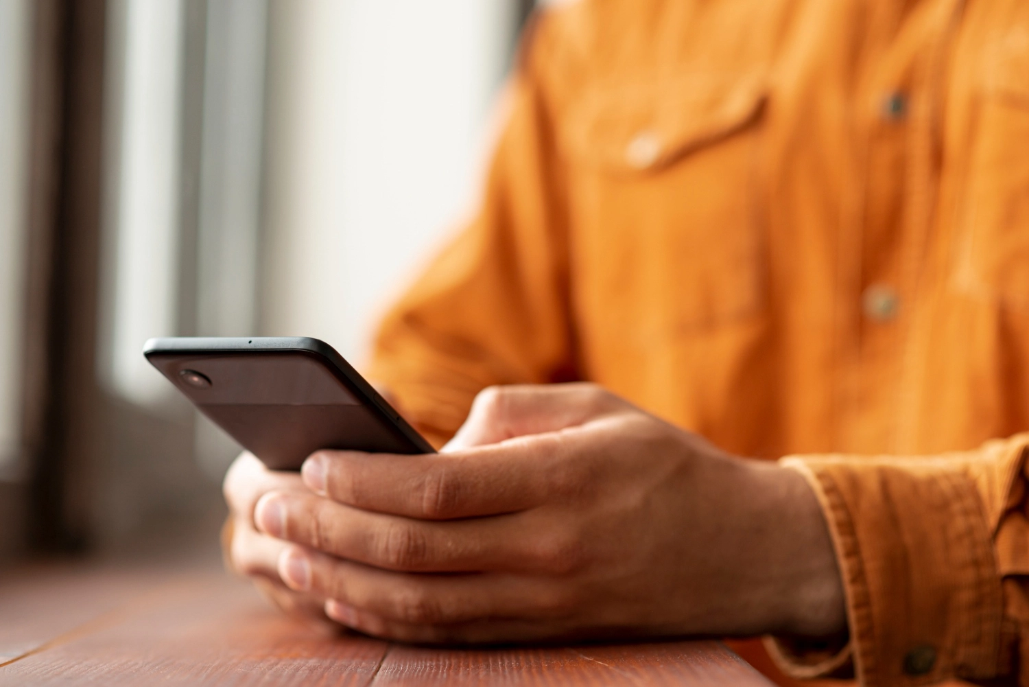 Person using a mobile phone to call for mental health support
