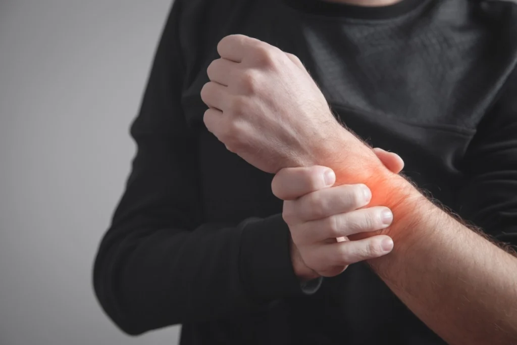 Man holding a swollen wrist