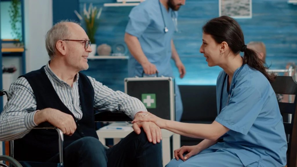 A nurse comforting a elderly gentleman